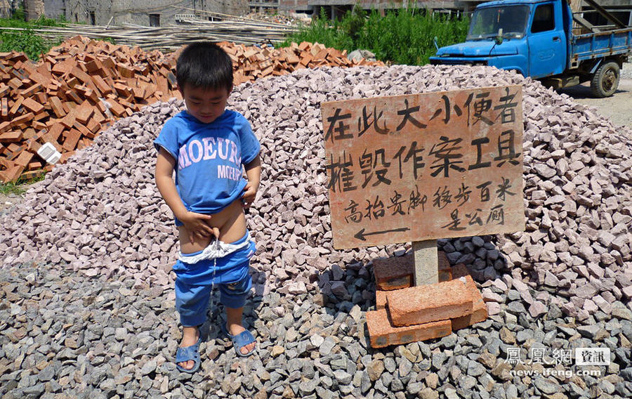 浙江省金华市，一小孩在提示有不能随地小便的告示牌面前小便。.jpg